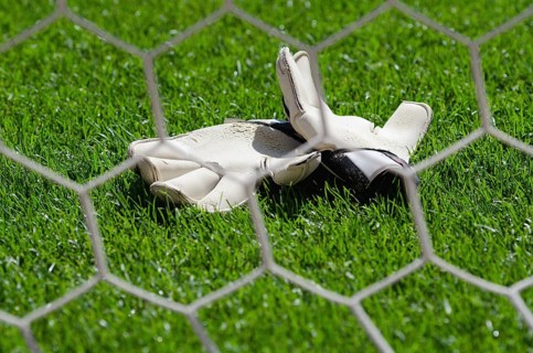Goalkeeper gloves on the grass on the football field in Wroclaw, Poand