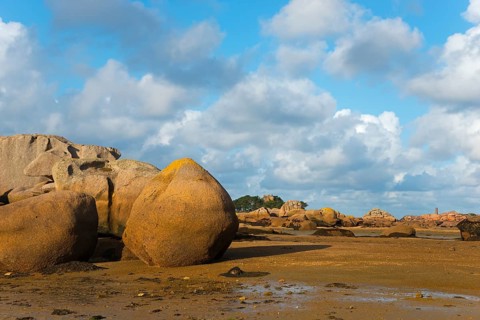 Large rocks under a partly cloudy sky on the coastal beach, Baie de Sainte-Anne, Trégastel,