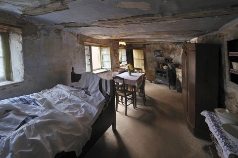 Interior of troglodyte house in rock face at Graufthal, Vosges, Alsace, France