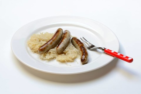 Nuremberg sausages with sauerkraut on a plate, Rostbratwurst, Germany