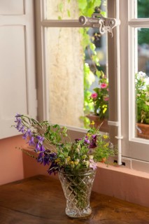 Old window with espagnolette, bouquet of flowers, Provence, France