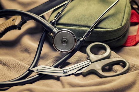 Stethoscope lies on the uniform of a US soldier. The concept of health care, military insurance,