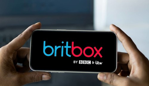 Britbox logo is displayed on smartphone. BritBox is an online digital video streaming subscription
