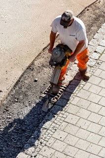 Construction worker with chipping hammer, chisel hammer, repair of road surface, asphalt, road
