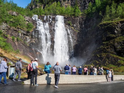 Group of tourist at waterfall Skjervsfossen, near Granvin, Hardanger, Norway
