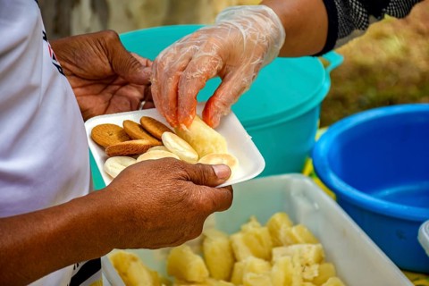 Person receiving food at a community breakfast Belo Horizonte, Minas Gerias, Brazil