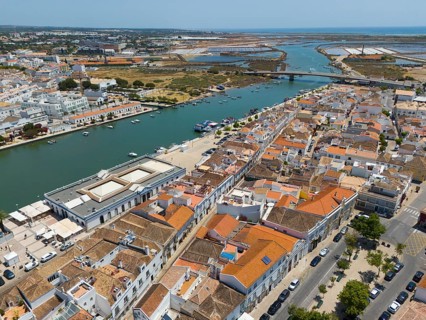 Town with numerous orange-coloured roofs along a river in summer weather, aerial view, Tavira,