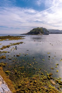 Low tide on the beach of Ondarreta in San Sebastián and the island in the background. Province of