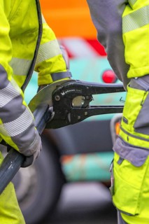 Close-up of workers in protective clothing installing a cable, Wend Glasfasermontage installing