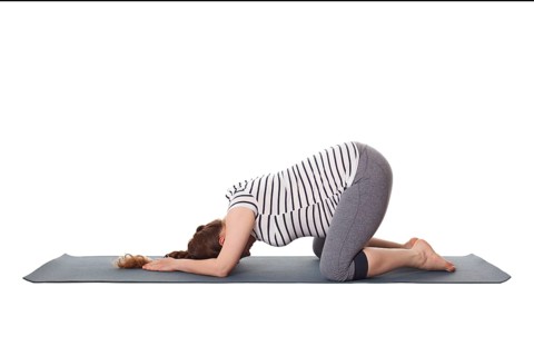 Pregnancy yoga exercise, pregnant woman doing asana Balasana, child s pose isolated on white