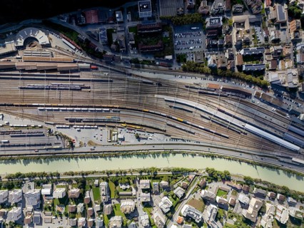 An aerial view of Brig railway station in Switzerland, showcasing a complex network of tracks and