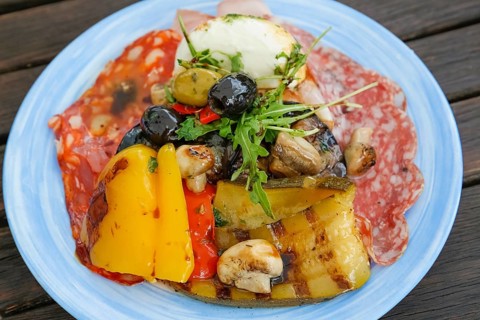 Mediterranean cuisine, grilled vegetables arranged on plates, mushrooms, mushrooms, red and yellow