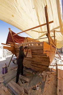 Indian man working at a dhow shipyard in Sur, Janub ash-Sharqiyya province, Oman