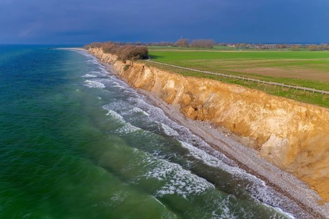 Aerial view over sea cliffs and crumbling shoreline near Wustrow on the Fischland peninsula along