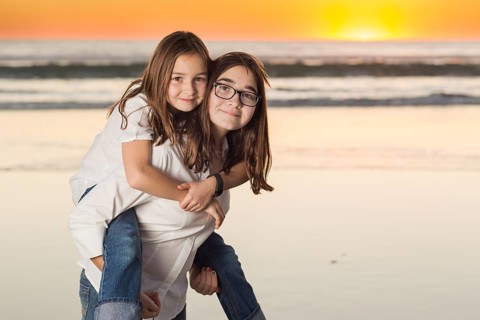 Two Young Sisters Portrait on The Beach