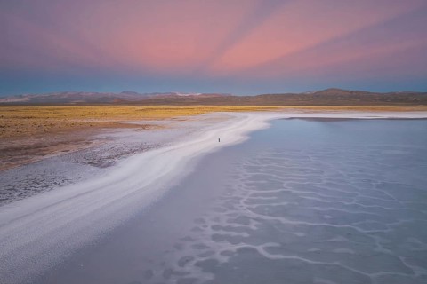 A stunning view of Salinas Grandes, Salta, Argentina, showcasing expansive salt flats under a