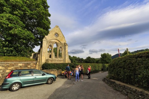 Visitors in front of an open-air concert in the evening, ruin, Abbey Farm, Llangollen, North Wales,