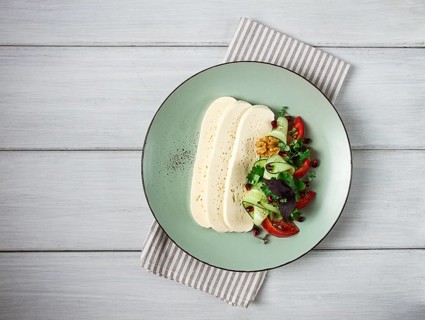 Sliced Imeruli cheese, Georgian cheese, with vegetables, top view, no people