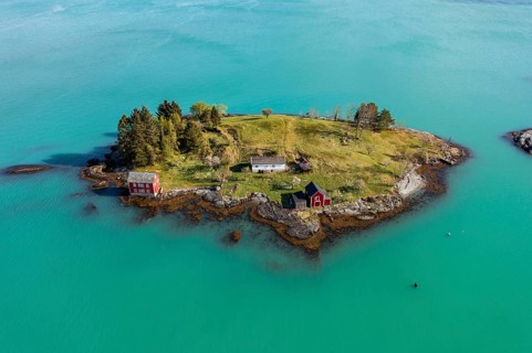 Aerial view of typical red houses on an island in the Hardangerfjord, near Strandebarm, Hordaland,