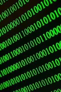 Green binary numbers displayed blurred and fast, conveys digital data