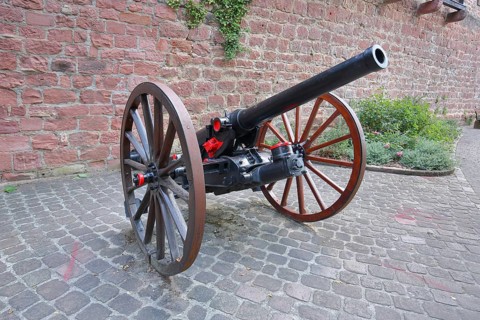 Medieval cannon with wagon wheels in front of the city wall at Pulverturm, Eberbach, Neckar Valley,