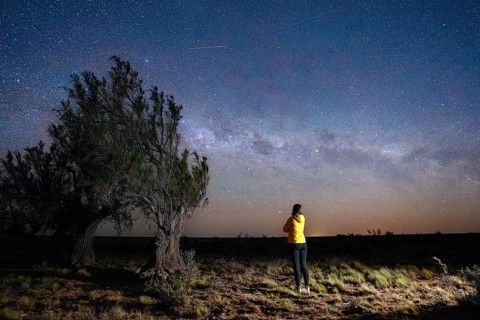 Young woman marvels at the stars of the Milky Way, Tres Cerros, Santa Cruz, Argentina