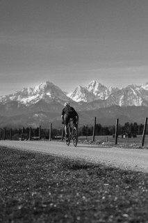 Road bike rider in spring near Halblech in the Allgäu in front of a picturesque backdrop of the