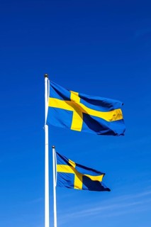 Swedish flags against a blue sunny sky on Swedens national day, Sweden