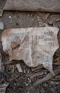 Remains of an instruction manual with circuit diagram in Cyrillic script in an abandoned building,