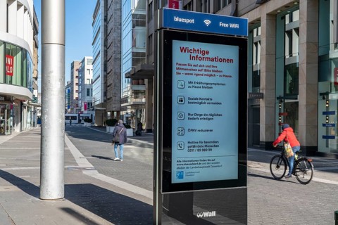 Advertising displays, give advice on correct behaviour, empty city centre, shopping street,