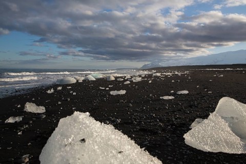 Little icebergs and crushed ice on the black beach at Joekulsarlon glacial lake