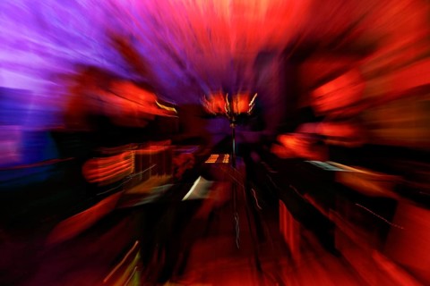 Dynamic stage set at a milonga, concert, tango dance event, motion blur, format-filling, orange,