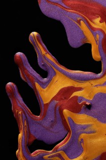 An artistic image of vibrant metallic paints swirling in deep purples, fiery oranges, and yellows