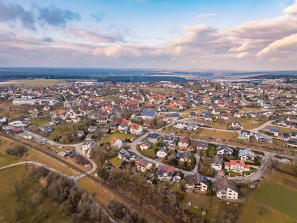 Built-up residential area in a picturesque landscape under a cloudy sky, Schopfloch, Freudenstadt