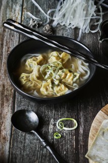 From above wonton soup on a wooden table