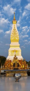 Chedi decorated with golden ornaments at Wat Phra That Phanom at sunrise, temple complex in Amphoe
