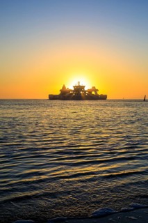 Ferry and sunset on the west coast of Norderney, Lower Saxony, Germany