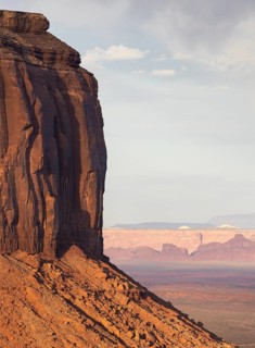 Stunning red rock formations dominate the landscape of Monument Valley. The towering cliffs and