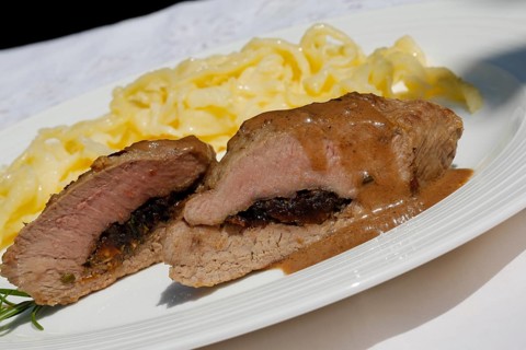 Swabian cuisine, lamb stuffed with prunes, rosemary, herbs, fillets arranged on plates,