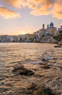 View of the village with the Greek Orthodox church of Agios Nikolaos, Asteria Beach, at sunset with