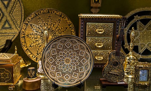 A collection of gold-decorated decorative objects, including plates and caskets with complex