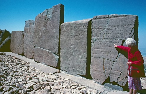 Tourist, labelled back of the relief panels, western terrace, Mount Nemrut Dagi, Taurus Mountains,
