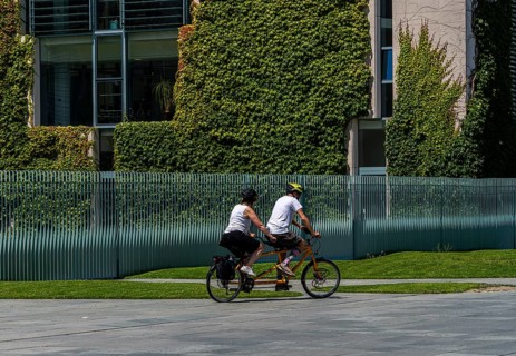 Tourists on bicycles, fence at the Federal Chancellery, Berlin, Germany