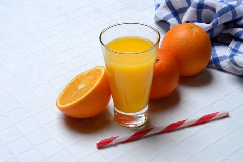 Orange juice in glass and orange