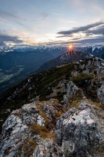Mountain panorama, mountain landscape with sun star at sunset, at the summit of the Kramerspitz, in