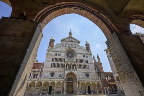 View of the Cathedral of Santa Maria Assunta from café under arcades, Cremona, Province of Cremona,
