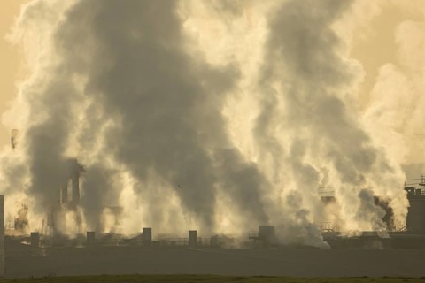 Chinmneys emitting steam or smoke from an industrial plant, England, United Kingdom