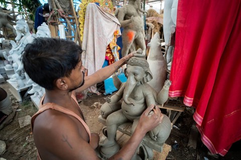 Artisan work on idols of the elephant-headed Hindu deity Ganesha at a workshop ahead of the Ganesh