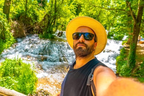 Tourist selfie right next to the waterfalls in the Monasterio de Piedra Natural Park, Aragon, Spain
