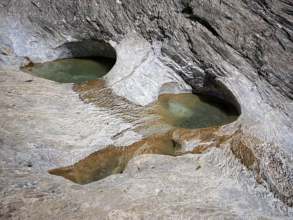 Glacier mill with glacier pots on the Trinser Alp Mora, Trin, Canton Graubünden, Switzerland